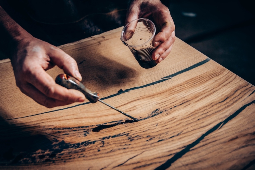 Manufacture of furniture from solid wood. treatment of a wooden table with varnish, epoxy resin, paint. handmade .